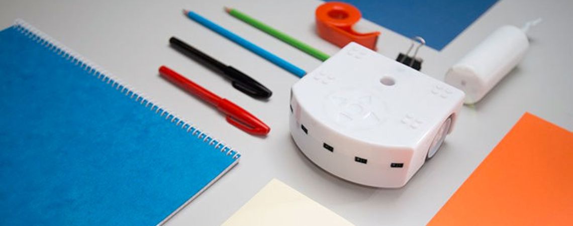 Thymio educational robot next to school supplies